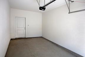 A room with a white door and a white wall.