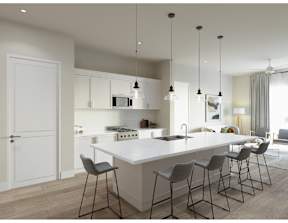 A modern kitchen with a white island and grey chairs.