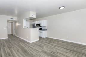 A kitchen with white cabinets and a microwave above the stove.