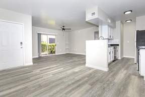 A spacious kitchen with a white cabinet and a ceiling fan.
