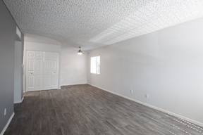 A room with a white door and a window.