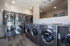 A row of LG front load washing machines in a laundromat.