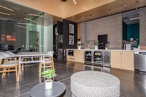 A modern kitchen with a dining table and chairs.