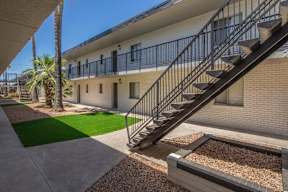 A building with a staircase and a palm tree.at Icon Apartments, Tucson, AZ