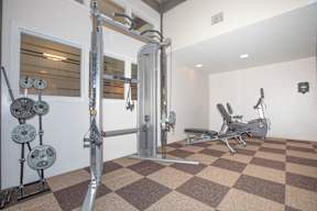 A home gym with a squat rack, bench, and weights.
