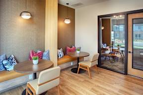A modern dining area with a round table and chairs.