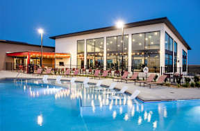 A large building with a pool in front of it.