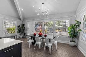 a dining room with a table and chairs and a large window