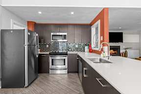 a kitchen with stainless steel appliances and white counter tops