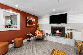 a living room with a fireplace and a tv