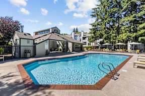 a swimming pool with a house in the background