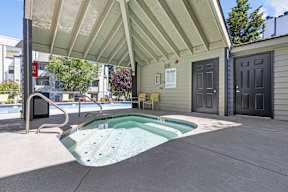 our hot tub is under our covered patio in front of our building with a door