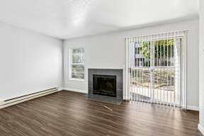 A room with a fireplace and sliding glass doors.