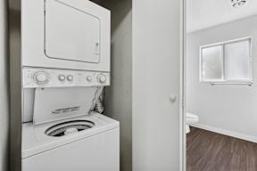 A white oven and stove top are in a kitchen.