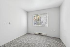 A room with a window and a bench.