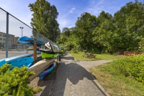 a park with a kayak rack and a picnic table