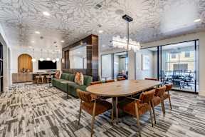 A conference room with a long table surrounded by chairs.