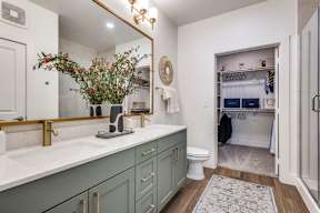 A bathroom with a green cabinet and a white counter top.
