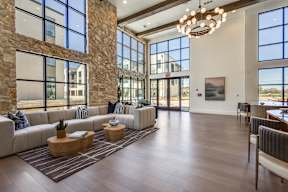 A modern living room with a stone wall and a large window.