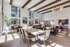 A modern dining room with a large table and chairs.
