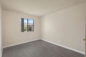 Empty room with a window and a door.