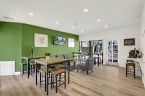 A room with a green wall and a wooden floor.