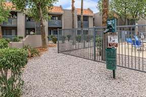 A gated community with a sign on a pole.