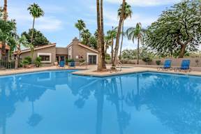 A house with a pool in front of it.