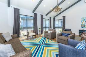 A living room with a colorful rug and two couches.