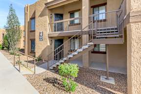 Apartment complex with a staircase leading to the second floor.