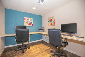 Two chairs and two desks in a room.