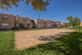 A sandy area in front of apartment buildings.