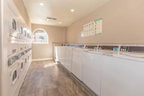 A row of washing machines in a public laundromat.