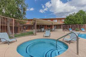A small pool with a metal fence around it.