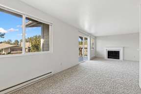 A room with a fireplace and a carpeted floor.
