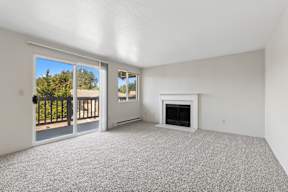 A room with a fireplace and sliding glass doors.