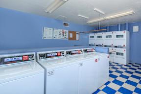 A row of washing machines in a laundromat.