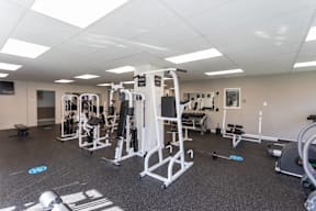 A gym with a variety of equipment including a leg press machine.