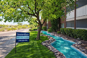 A sign in front of a building advertises that move-ins are available.