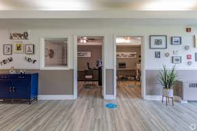 A room with a blue cabinet and a white fridge.