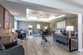 A modern office space with a variety of furniture and decor.