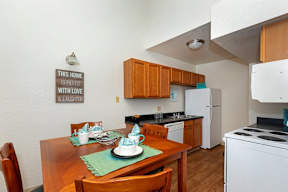 A kitchen with a sign that says "This home is filled with love and laughter.".