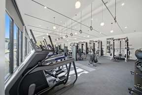 A gym with treadmills, weights, and exercise equipment.