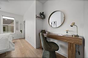 A room with a desk and chair in it.