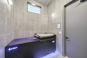 A modern bathroom with a Sunrise hot tub.