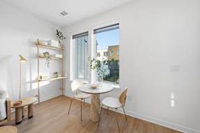 A white room with a table and chairs.