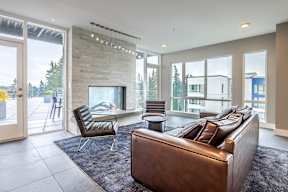 a living room with a leather couch and a fireplace
