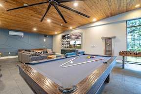 a pool table in the living room of a house
