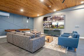 a living room with couches and a tv on the wall