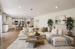 A modern living room with a large sectional sofa and a coffee table.